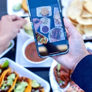 a person taking a picture of their food