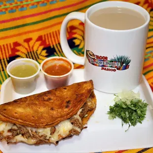 a plate of quesadillas and a cup of salsa