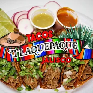 a plate of tacos with sauce and salsa