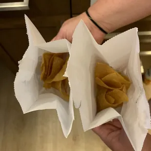 a person holding two tacoss