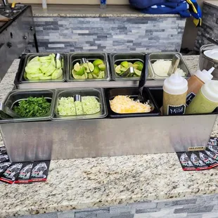 Toppings and salsas stay fresh in our our iced toppings station