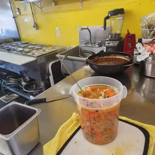 a pot of soup on a cutting board