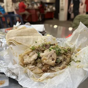 a taco filled with meat and vegetables