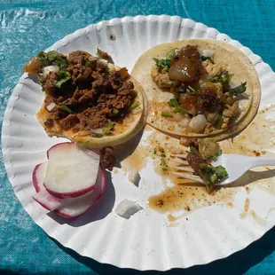 two tacos on a paper plate