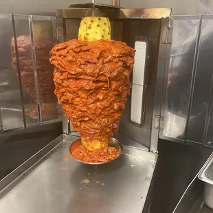a chicken kebab being cooked in a commercial kitchen