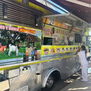 a woman ordering from a food truck