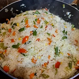 a pan filled with rice and vegetables