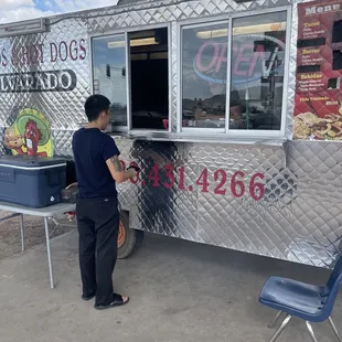 a woman ordering food from a food truck