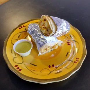 a plate with a burrito on it