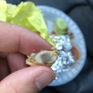 a hand holding a piece of food