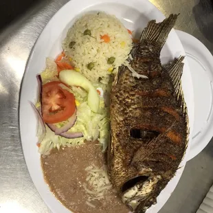 a plate of fish and rice