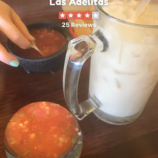a woman&apos;s hand reaching for a drink