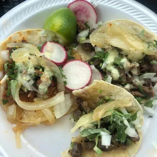 a plate of tacos and a lime