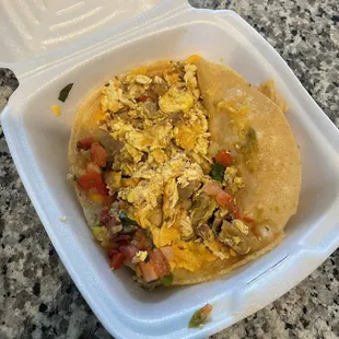 a taco in a styrofoam container