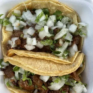 Bistec and Pastor tacos on corn tortillas