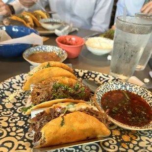 a variety of tacoss on a plate