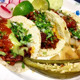 Pastor and chicken tacos with lime, radish, cucumber and jalapeño on the side!