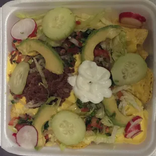 Veggie nachos $4, thoughtfully assembled by a woman