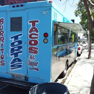 a taco truck parked on the side of the road