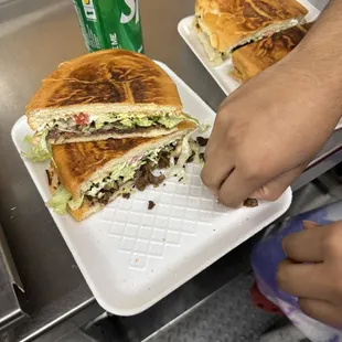 a person cutting a sandwich