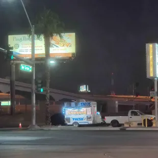 a taco truck parked on the side of the road