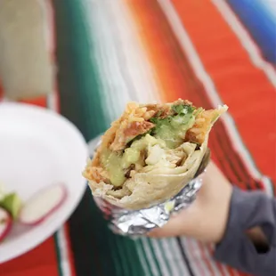 a person holding a burrito