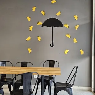 a table with chairs and an umbrella