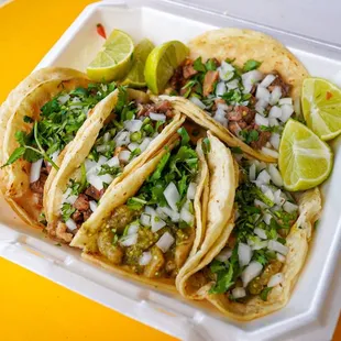 three tacoses in a styrofoam container