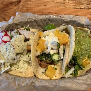 Blackened fish taco on the left, Carnitas with mango in the center and Carne Asada with guacamole on the right