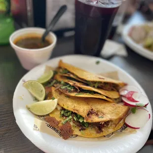 a plate of tacos and a drink