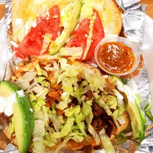 a sandwich with lettuce and tomatoes
