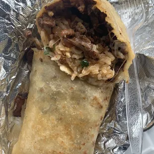 Asada burrito without beans or lettuce. Well seasoned meat, cheese, rice, pico de Gallo, on a buttery griddled tortilla!