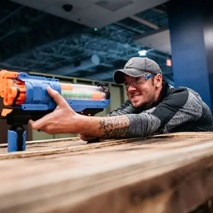 Sharp aim and a steady hand, this dad is locked in for a perfect shot at Tactical Urban Combat