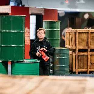 Stealth mode on! A young player navigates the Tactical Urban Combat arena, poised for Nerf action