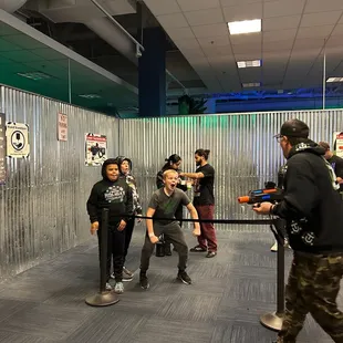 Excitement mounts as players queue for laser tag. Tactical Urban Combat is where strategy and fun meet!
