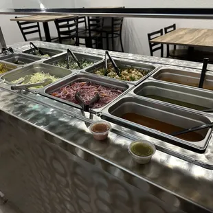 condiment station with onions, salsa, etc