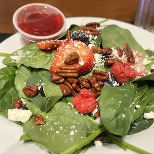 a plate of spinach salad
