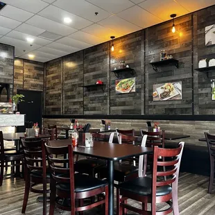 a dining area with tables and chairs