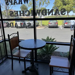 a table and chairs in front of a window