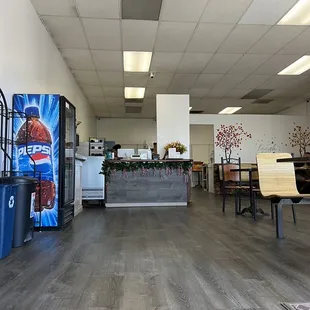 the inside of a restaurant with tables and chairs