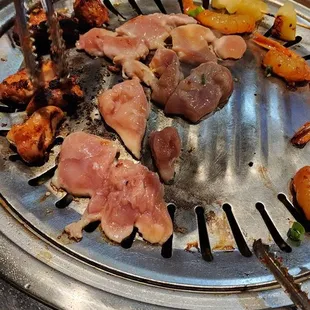 a grill with meat and vegetables on it