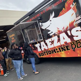 people standing in front of a food truck