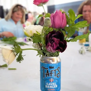 a can with flowers in it