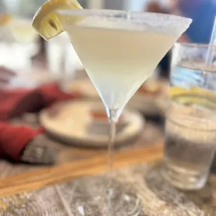 a martini with a slice of lemon on the rim