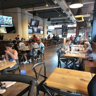 people sitting at tables in a restaurant