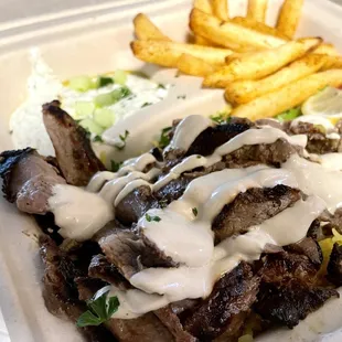 a plate of meat and fries
