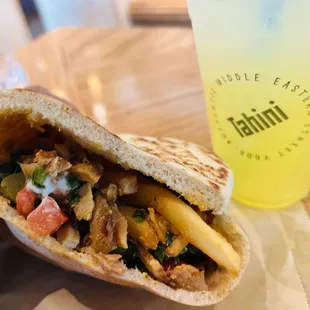 The Esquire Pita Sandwich with chicken Sriracha Tahini, French fries and mango lemonade.