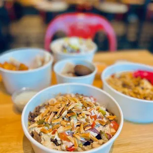 three bowls of food on a table