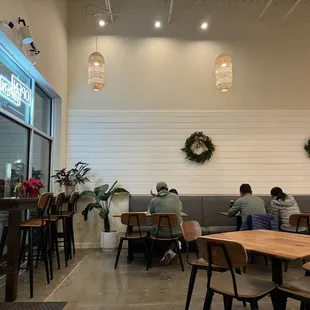 people sitting at tables in a restaurant