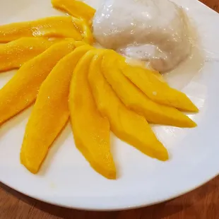 mangoes and ice cream on a white plate